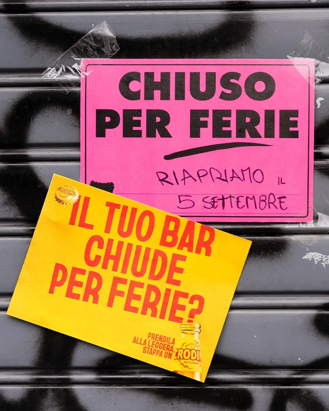 Cartello giallo Crodino con scritta “Il tuo bar chiude per ferie?” su saracinesca chiusa