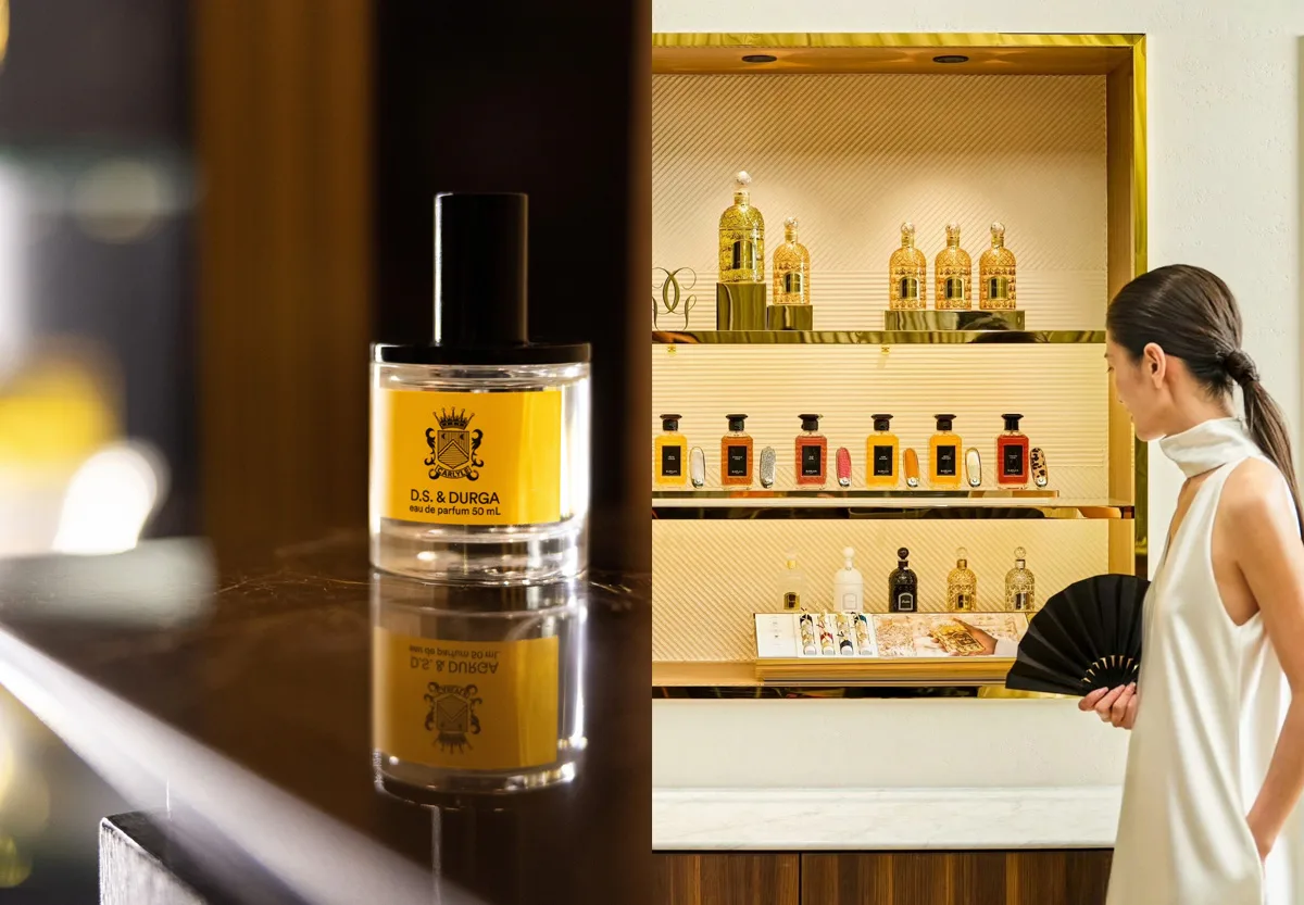 Flacone di profumo D.S. & Durga su ripiano scuro e donna che osserva flaconi Guerlain su scaffali dorati.